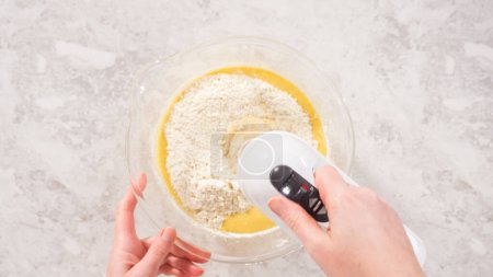 Photo for Flat lay. Step by step. Mixing ingredients in a glass mixing bowl to bake funfettti bundt cake. - Royalty Free Image
