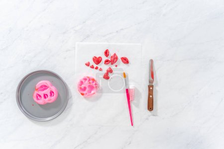 Photo for Flat lay. Dusting chocolate lips and heart-shaped chocolates with editable glitter for Valentines Day. - Royalty Free Image