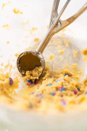 Photo for Scooping cookie dough with a dough scoop to bake unicorn chocolate chip cookies. - Royalty Free Image