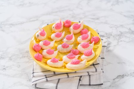Photo for Freshly baked Easter meringue cookies in the shape of birds. - Royalty Free Image