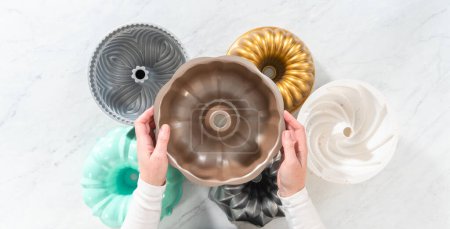 Photo for Flat lay. Variety of bundt cake pans on the kitchen counter. - Royalty Free Image