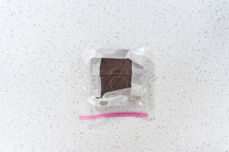 Photo for Flat lay. Storing plain homemade fudge into the reusable plastic bag. - Royalty Free Image