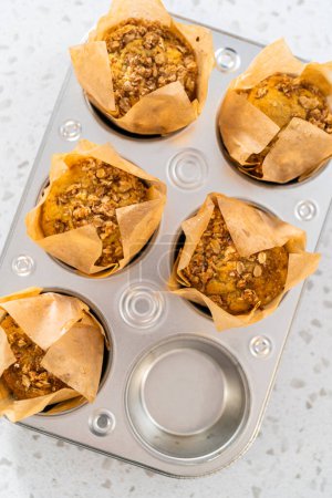 Photo for Freshly baked banana oatmeal muffins in a small muffin pan. - Royalty Free Image