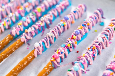 Photo for Mermaid chocolate pretzel rods drizzled with pink and purple chocolate and covered with sprinkles. - Royalty Free Image