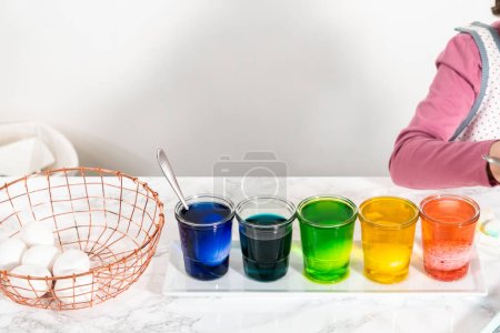 Photo for Easter egg coloring. Dye white organic eggs in different colors for Easter. - Royalty Free Image