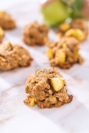 Photo for Freshly baked apple oatmeal with apple chunks cookies on a marble background. - Royalty Free Image