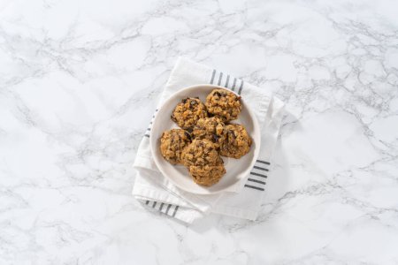 Photo for Flat lay. Freshly baked soft oatmeal raisin walnut cookies. - Royalty Free Image