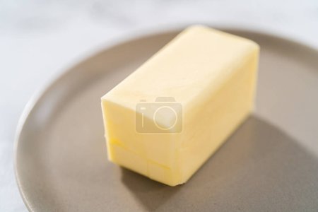 Photo for Sticks of unsalted butter on the small plates. - Royalty Free Image