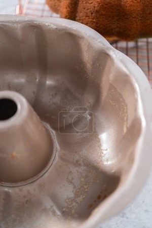 Photo for Cooling freshly baked bundt cake on a round cooling rack. - Royalty Free Image