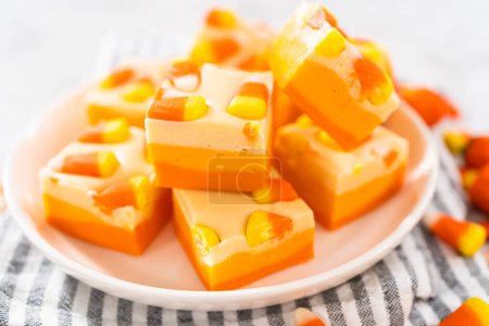 Photo for Homemade candy corn fudge square pieces on a white plate. - Royalty Free Image