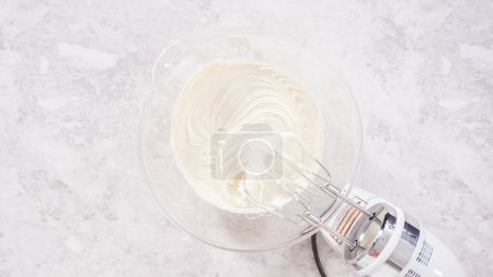 Photo for Flat lay. Step by step. Whipping store-bought vanilla buttercream frosting for decorating funfettti bundt cake. - Royalty Free Image