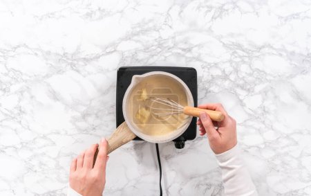 Photo for Flat lay. Prepare toffee glaze in a small sauce pan over an electric stove. - Royalty Free Image