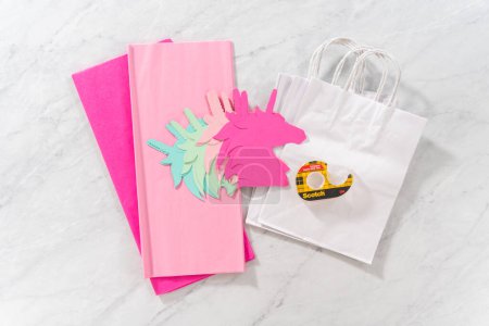 Photo for Denver, Colorado, USA-November 8, 2021 - Flat lay. Materials to make unicorn Birthday party favor bags for a little girls Birthday party. - Royalty Free Image