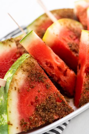 Photo for Chili lime watermelon pops on a white serving plate. - Royalty Free Image