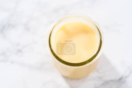 Photo for White chocolate ganache in a small glass mason jar. - Royalty Free Image