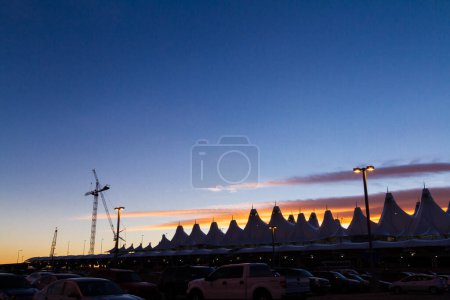 Photo for Denver, Colorado-January 19, 2013:Tents of DIA at sunrise. Denver International Airport well known for peaked roof. Design of roof is reflecting snow-capped mountains. - Royalty Free Image