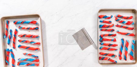 Photo for Flat lay. Rising patriotic cinnamon twists on the baking sheet lined with parchment paper. - Royalty Free Image