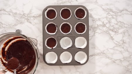 Photo for Flat lay. Step by step. Baking chocolate cupcakes. Scooping chocolate cupcake batter into a cupcake pan. - Royalty Free Image