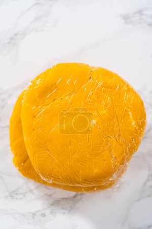 Photo for Lemon wedge cookies with lemon glaze. Wrapping cookie dough for chilling in the refrigerator to bake lemon wedge cookies with lemon glaze. - Royalty Free Image