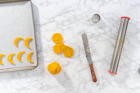 Photo for Flat lay. Lemon wedge cookies with lemon glaze. Rolling cookie dough with an adjustable rolling pin and cutting out cookies with cookie cutters to bake lemon wedge cookies with lemon glaze. - Royalty Free Image