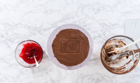 Photo for Flat lay. Covering chocolate cake with a crumb layer of chocolate buttercream frosting. - Royalty Free Image