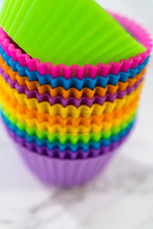 Photo for New silicone cupcake liners of different colors on the kitchen counter. - Royalty Free Image
