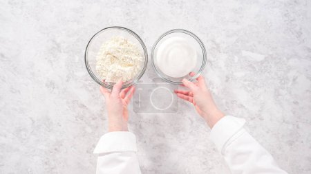Photo for Flat lay. Step by step. Ingredients in glass mixing bowls to bake funfettti bundt cake. - Royalty Free Image