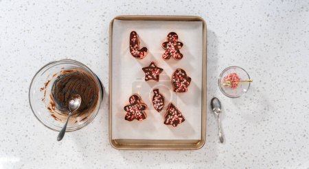 Photo for Flat lay. Filling cookie cutter with fudge mixture to prepare Christmas cookie-cutter peppermint fudge. - Royalty Free Image