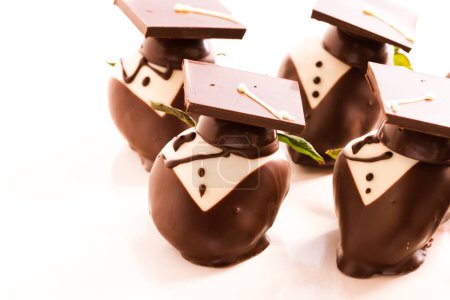 Photo for Gourmet chocolate covered strawberries decorated for graduation party. - Royalty Free Image