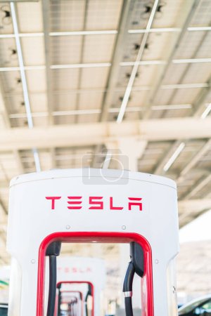 Photo for Baker, California, USA-October 12, 2021 - Tesla supercharging station during the day. - Royalty Free Image