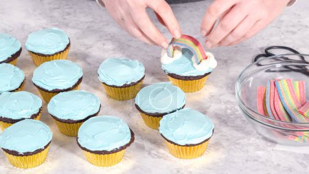 Photo for Step by step. Decorating chocolate cupcakes with buttercream frosting and rainbow candy. - Royalty Free Image
