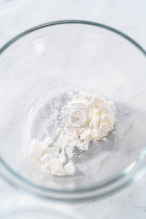 Photo for Measured ingredients in small glass mixing bowls to make powdered sugar dusting. - Royalty Free Image