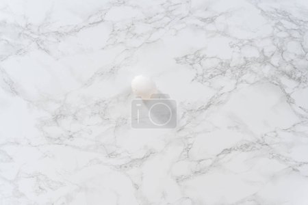 Photo for Peeling hard-boiled eggs at the marble kitchen counter. - Royalty Free Image