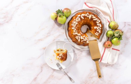 Photo for Flat lay. Slice of homemade apple bundt cake with caramel glaze on a plate. - Royalty Free Image