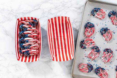 Téléchargez les photos : Flat lay. American flag. Red, white, and blue chocolate-covered pretzel twists. - en image libre de droit