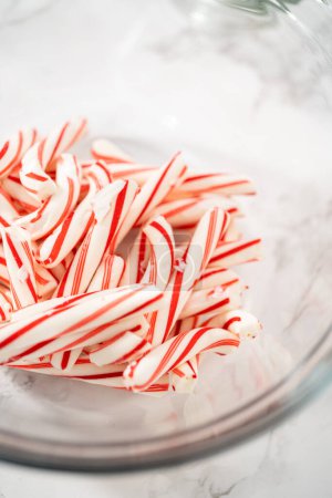 Photo for Measured ingredients in a glass mixing bowl to prepare peppermint buttercream frosting. - Royalty Free Image