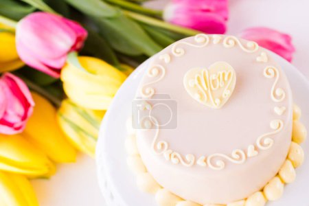 Photo for White chocolate honey lavender cake made with sponge cake infused with honey and filled with layers of lavender mousse, covered in white chocolate. - Royalty Free Image