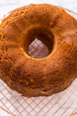 Photo for Cooling freshly baked eggnog bundt cake on a kitchen counter. - Royalty Free Image
