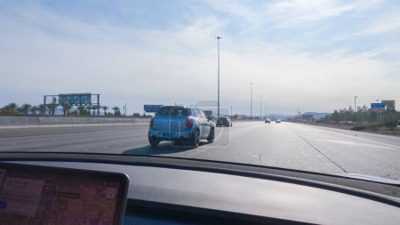 Photo for Las Vegas, Nevada, USA-December 3, 2022-Cruising through Las Vegas in a sleek Tesla vehicle on Highway 15 during the day adds an extra touch of luxury and sustainability to your road trip adventure to - Royalty Free Image