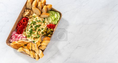 Photo for Flat lay. A large vegetarian party butter board with fresh and pickled vegetables and sliced french baguette for a party. - Royalty Free Image