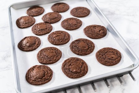 Photo for Cooling freshly baked chocolate cookies with chocolate hearts for Valentines Day on a kitchen counter. - Royalty Free Image