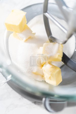 Photo for Mixing ingredients in kitchen electric mixer to bake American flag mini cupcakes. - Royalty Free Image