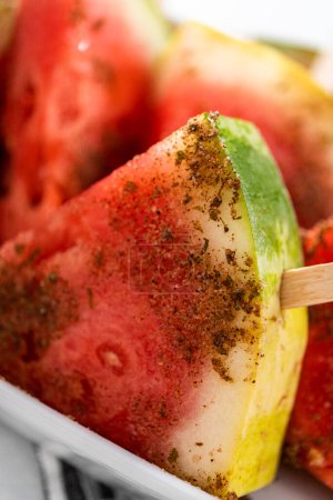 Photo for Chili lime watermelon pops on a white serving plate. - Royalty Free Image