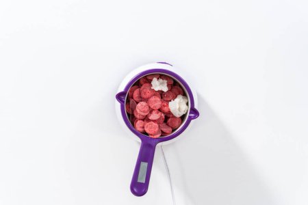 Photo for Flat lay. Melting chocolate chips in a candy melting pot to make chocolate-covered pretzel rods for Valentines Day. - Royalty Free Image