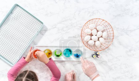 Photo for Flat lay. Easter egg coloring. Mixing food coloring with water and a dash of white vinegar to dye Easter eggs. - Royalty Free Image