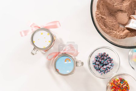 Photo for Flat lay. Making unicorn hot chocolate mix in drinking mason jar as a food gift. - Royalty Free Image