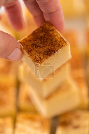 Photo for Homemade eggnog fudge pieces on a white cutting board. - Royalty Free Image