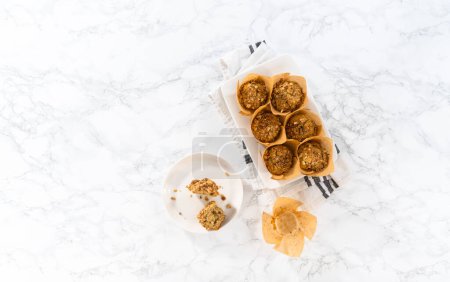 Photo for Flat lay. Freshly baked banana oatmeal muffins with oatmeal sugar topping. - Royalty Free Image