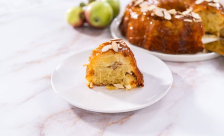 Photo for Slice of homemade apple bundt cake with caramel glaze on a plate. - Royalty Free Image