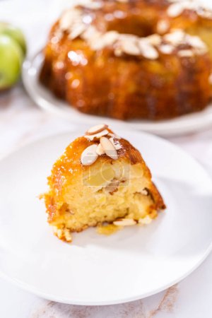 Photo for Slice of homemade apple bundt cake with caramel glaze on a plate. - Royalty Free Image